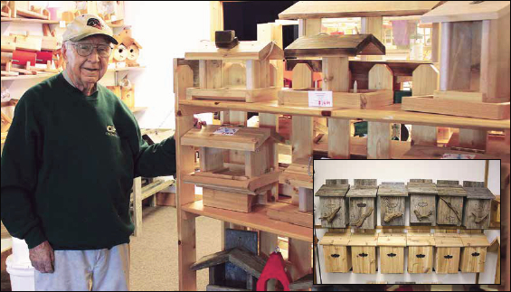 Gordon Seimers stands next to bird feeders of his creation at his Crosslake store, Birds, Bats and Beyond. The store also sells Siemers' bat houses (above inset).